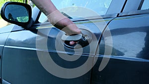 Man opens his hand door of black car Close up