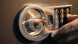 Man opens the safe with a coded lock close up