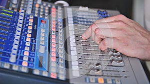 A man operates a mixing console.