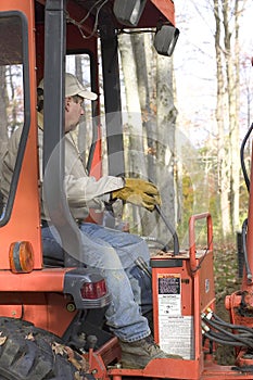 Man operating backhoe