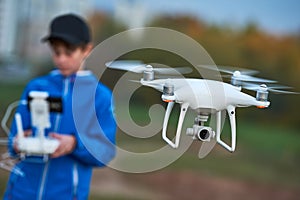 Young man operating of flying drone at sunset