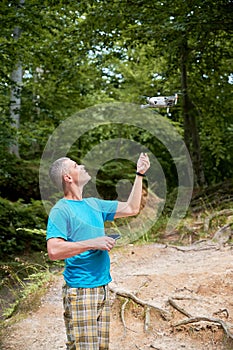 Man operating drone using remote controller.