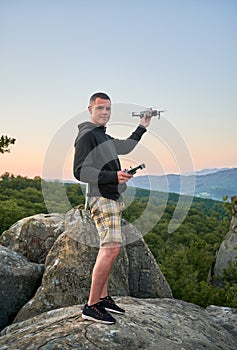 Man operating drone using remote controller.