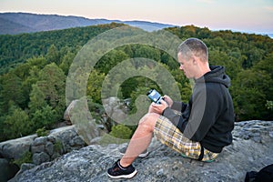 Man operating drone using remote controller.