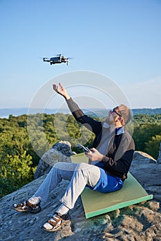 Man operating drone using remote controller.