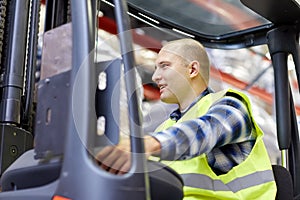 Man operating forklift loader at warehouse