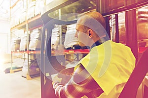 Man operating forklift loader at warehouse