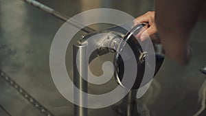 Man Operating a Metal Disk Rotation Mechanism by Water