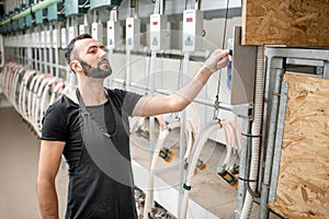 Man operating milking machine at the goat farm