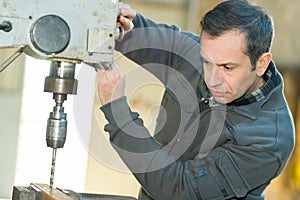 man operating milling machine