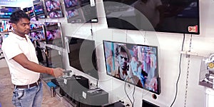 man operating television at showroom in India
