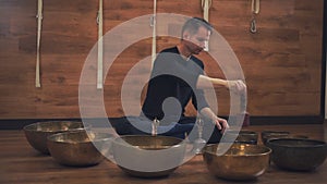 Man operating with Tibetan singing bowls