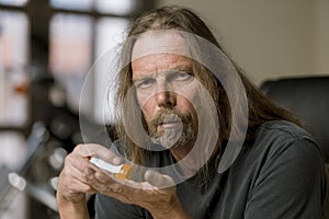 Man with an Opioid Prescription Pill Bottle