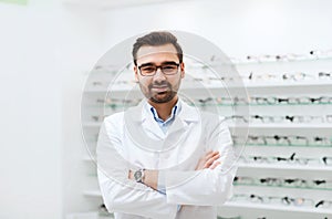 Man optician in glasses and coat at optics store