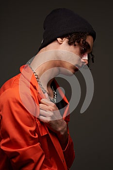 man in orange uniform crime gangster dark background