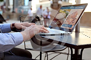 Man is ordering food on the internet using an app, restaurant meals delivery online