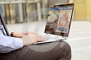 Man is ordering food on the internet using an app, restaurant meals delivery online