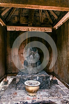 Man Organ Statue and Prayer Incense Inside Cetho Temple at Karanganyar Tawangmangu Central Java Indonesia photo