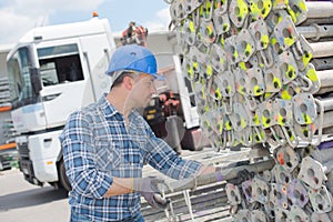 Man organizing scaffolding poles