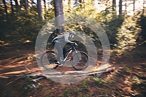 Man, outdoor and cycling in nature for sports, exercise or training on a mountain bike with speed. Athlete male person