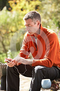 Man Outdoors Listening To MP3 Player photo