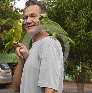 Man outside with his Blue Fronted Amazon Parrot
