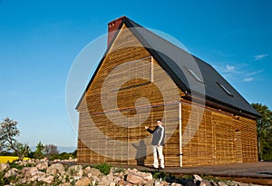 Man outside wooden home