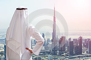 Man Outstretching His Hand At Modern Buildings In Dubai