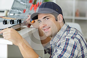 Man in overall installing kitchen
