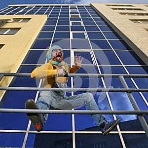 Man in overalls on background glassed building