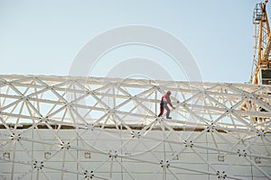 Man in overalls builder fixes on the height