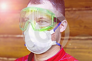 a man in overalls, a protective mask and a respirator