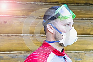 a man in overalls, a protective mask and a respirator