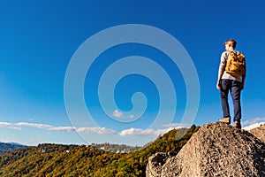 Man overlooking the mountains belown photo