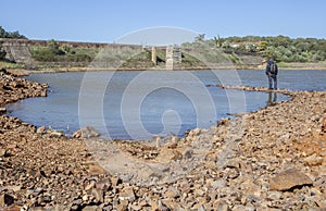 Man overlooking the Roman Dam of Cornalvo