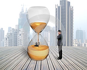 Man oversee businessman flooded in hourglass