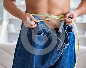 Man in oversized pants in weight loss concept