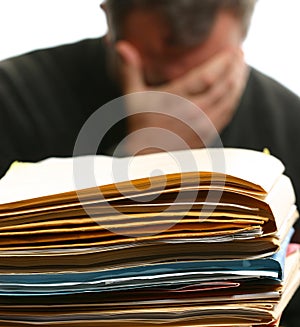 Man overwhelmed with office work photo