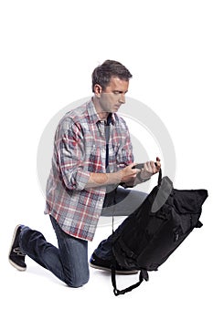 Man Packing Bag and Preparing to Travel or Hike