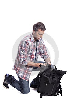 Man Packing Bag and Preparing to Travel or Hike