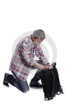 Man Packing Bag and Preparing to Travel or Hike