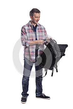 Man Packing Bag and Preparing to Travel or Hike