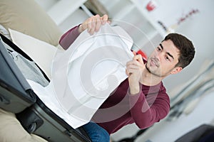 Man packing clothes into travel bag