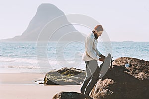 Man packing his backpack with sea view