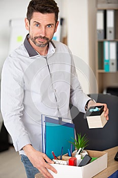 man packing office possessions photo