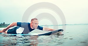 Man padding to line up on the surf board