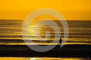 Man Paddle Surfing at Sunrise