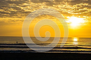 Man Paddle Surfing at Sunrise