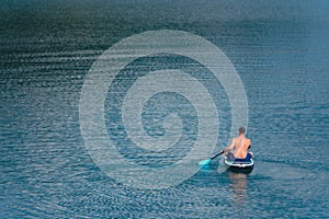 man on paddleboard in the middle of the lake