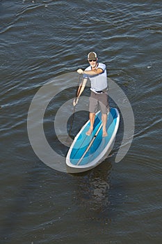 Man paddleboarding, overhead shot photo
